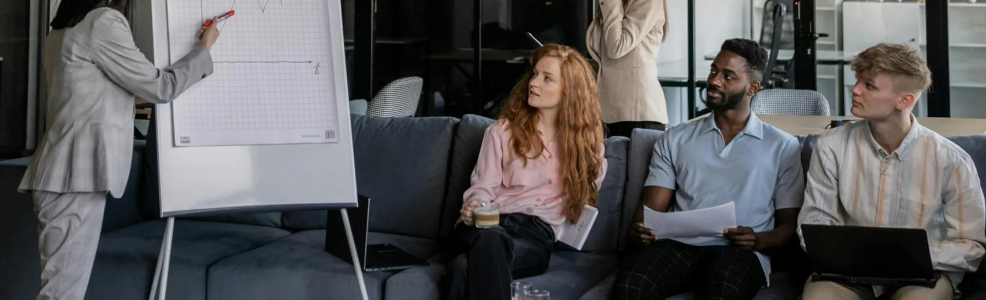 Colleagues brainstorm during a business meeting in a stylish office space.