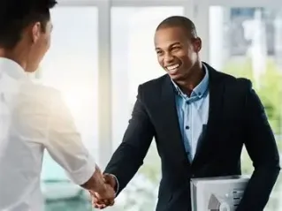Two professionals discussing a colorful business graph during a meeting.