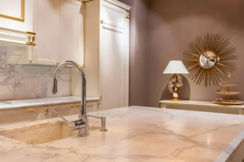 Bright kitchen with marble countertops, modern faucet, and stylish decor.