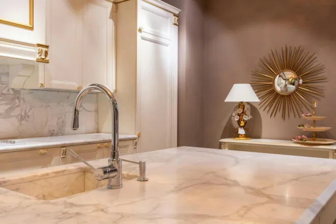 Bright kitchen with marble countertops, modern faucet, and stylish decor.