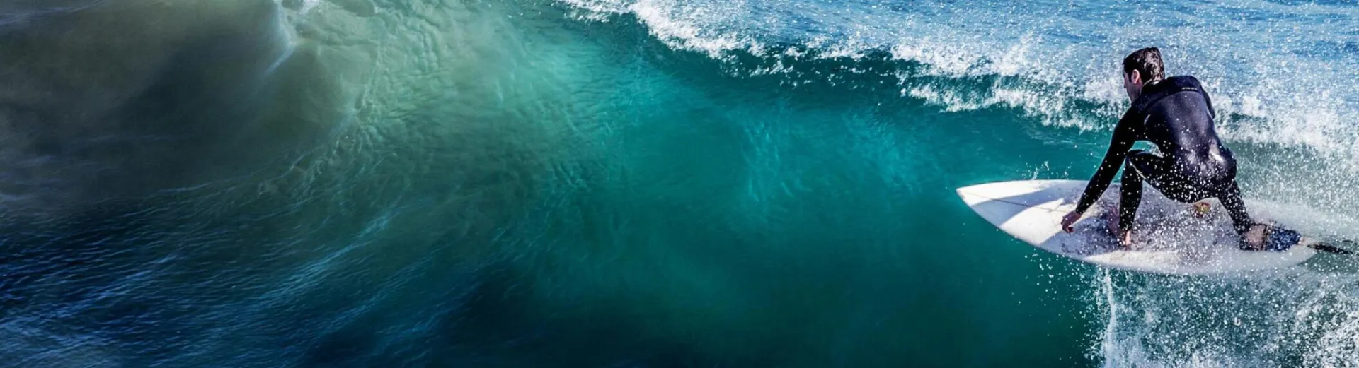 A thrilling capture of a surfer skillfully riding a wave in the open ocean, showcasing the excitement of surfing.