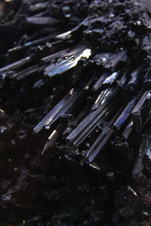 Close-up view of dark crystal formations displaying rough textures and natural mineral beauty.