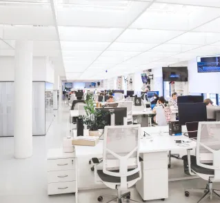 Spacious and well-lit office interior with modern furniture and workstations, ideal for a dynamic work environment.