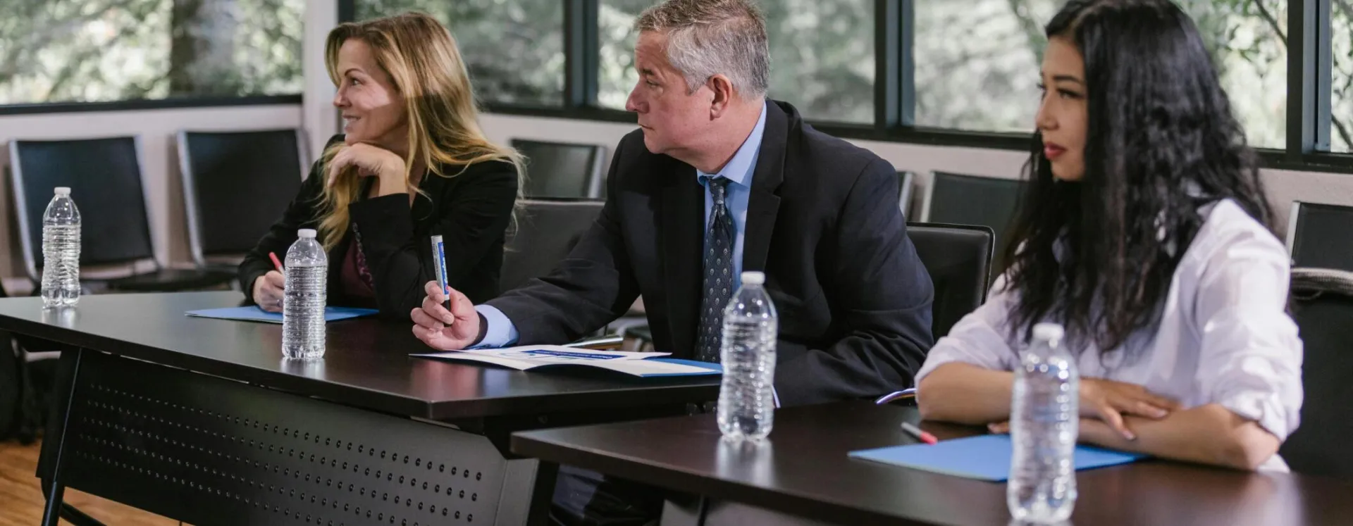 Diverse professionals engaged in a business meeting in a modern conference room.