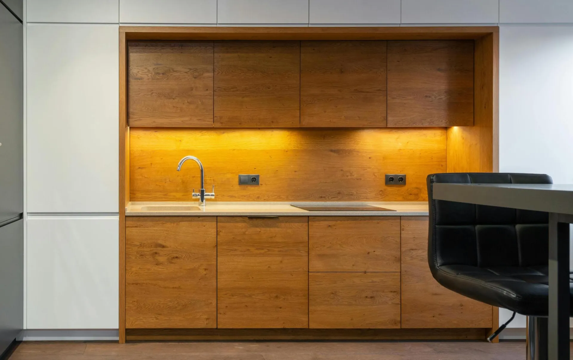 Explore a sleek and contemporary kitchen with wood accents and ample lighting.