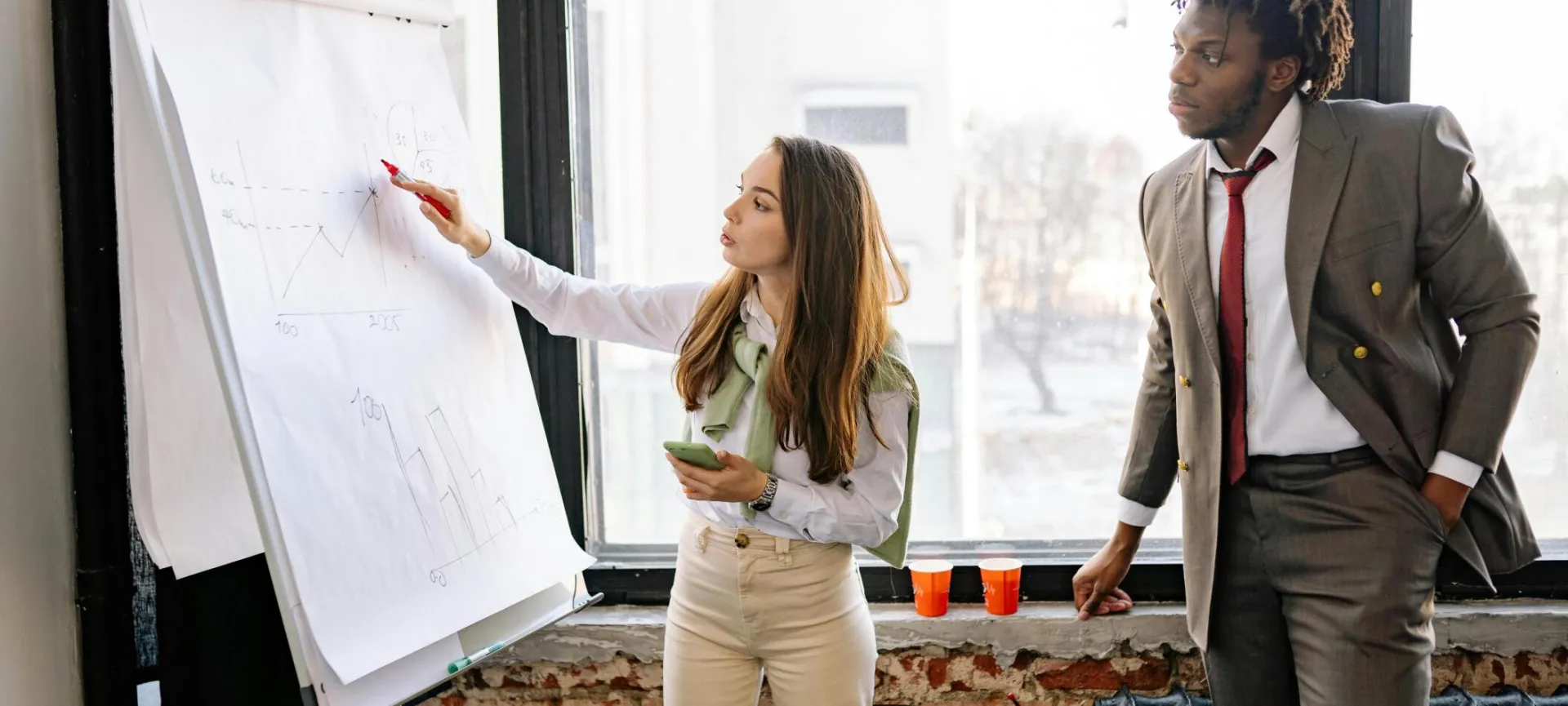 Corporate team discussing business strategies during an office presentation.
