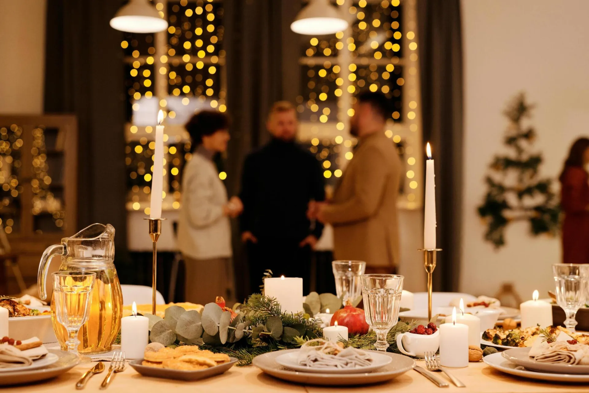 A beautifully set dining table with candles and decorations, perfect for a cozy Christmas celebration.