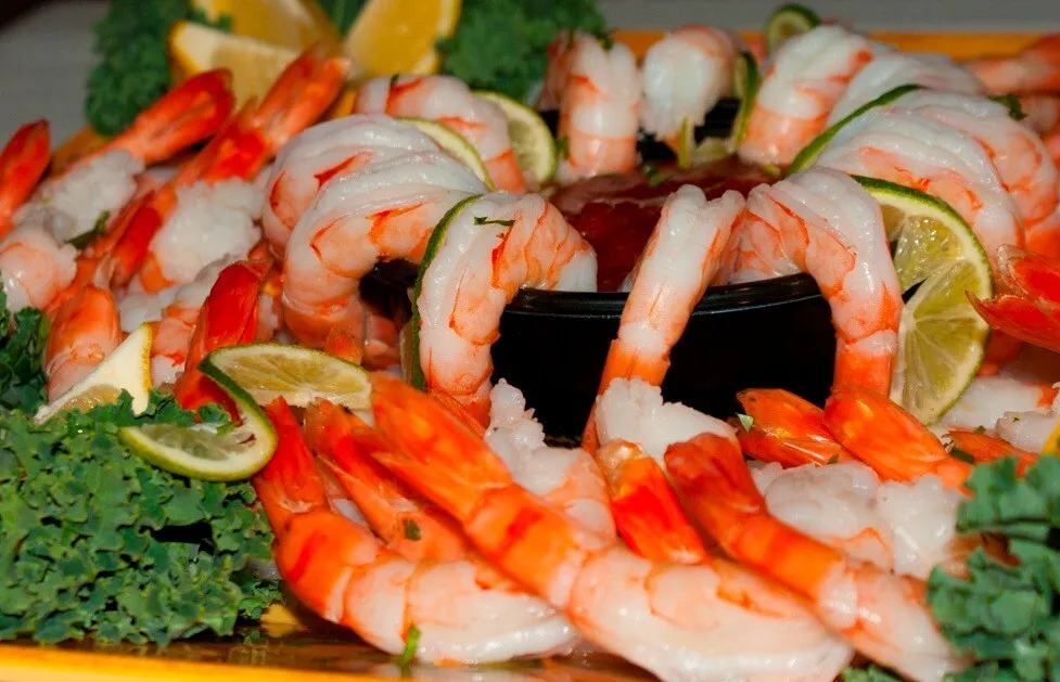 A mouth-watering assortment of cheeses, breadsticks, and fruits in a buffet setting. Perfect for catering events.
