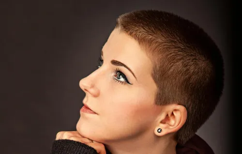 Profile portrait of a woman in trendy short hairstyle and scarf, deep in thought.