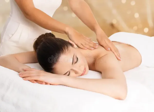 Woman enjoying a relaxing massage therapy session at the spa. Ideal for wellness or relaxation themes.