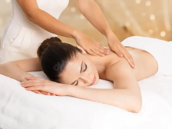 Woman enjoying a relaxing massage therapy session at the spa. Ideal for wellness or relaxation themes.