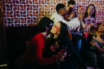 A lively celebration with friends enjoying drinks and laughter in a festive setting.