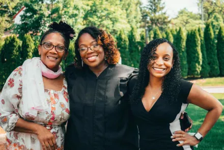 Graduation celebration with happy family outdoors. Smiling women enjoying a sunny day.
