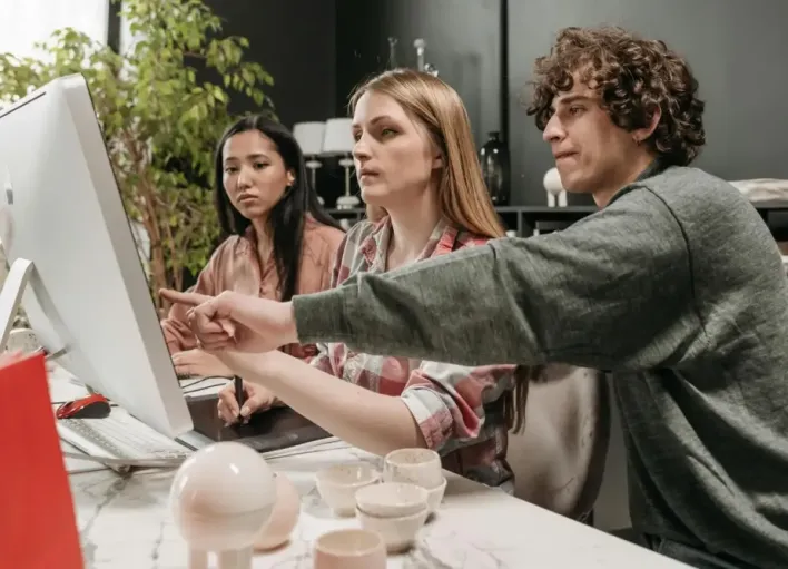 A diverse team discusses strategies in a modern office setting, using technology to enhance creativity.