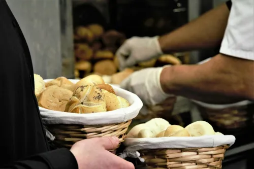 Close-up of fresh bread in woven baskets at a bakery. Perfect for food and business themes.