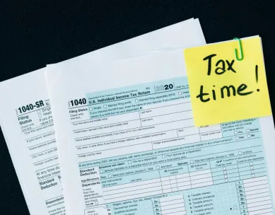 U.S. tax documents with a 'Tax time!' reminder, highlighting the importance of filing deadlines.