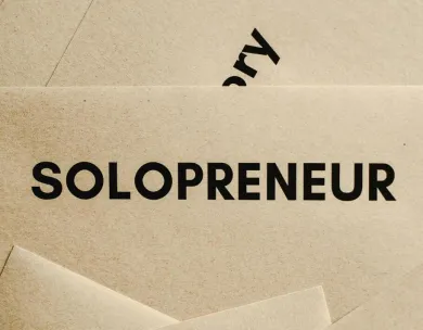 Minimalist solopreneur business cards laid out conceptually in a creative stack.