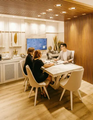 A group of professionals engaging in a meeting within a stylish office setting, fostering teamwork and cooperation.