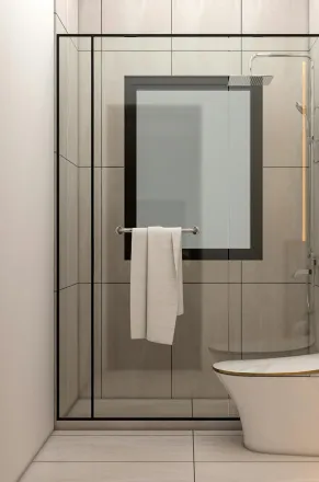 Elegantly designed bathroom featuring a glass shower and sleek toilet, highlighting modern minimalism.