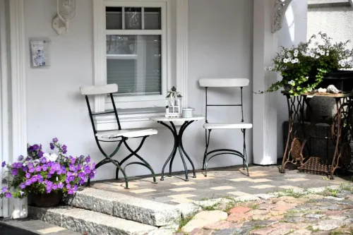 Inviting outdoor seating area with chairs and flowers in Timmendorfer Strand, Germany.