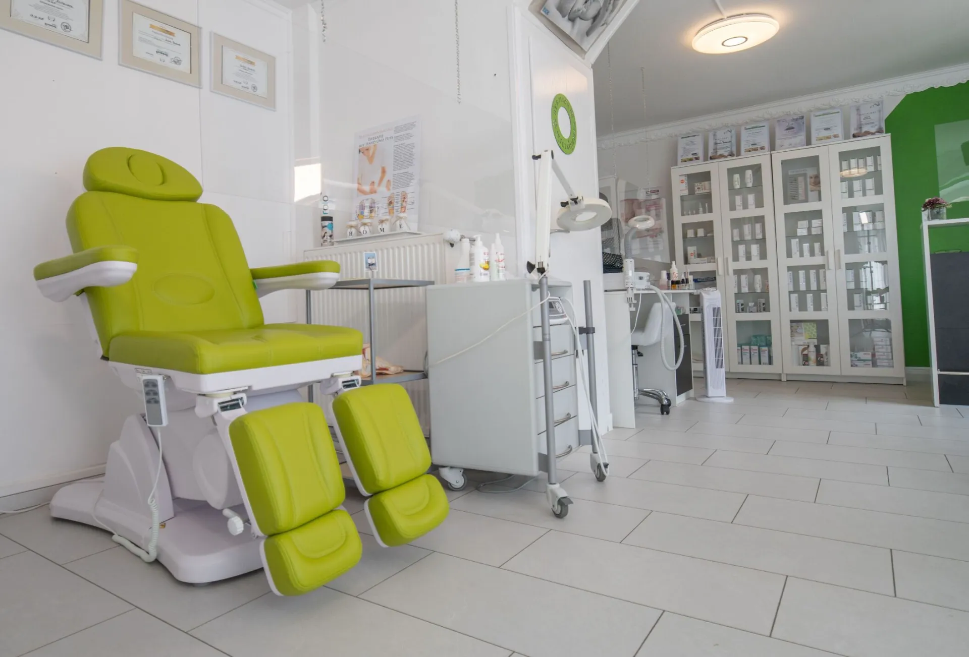 Professional equipment in doctor office with couch for medical treatment procedures behind protective screen