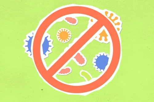 Overhead view of cutout paper composition representing forbidding symbol and different bacteria on green background