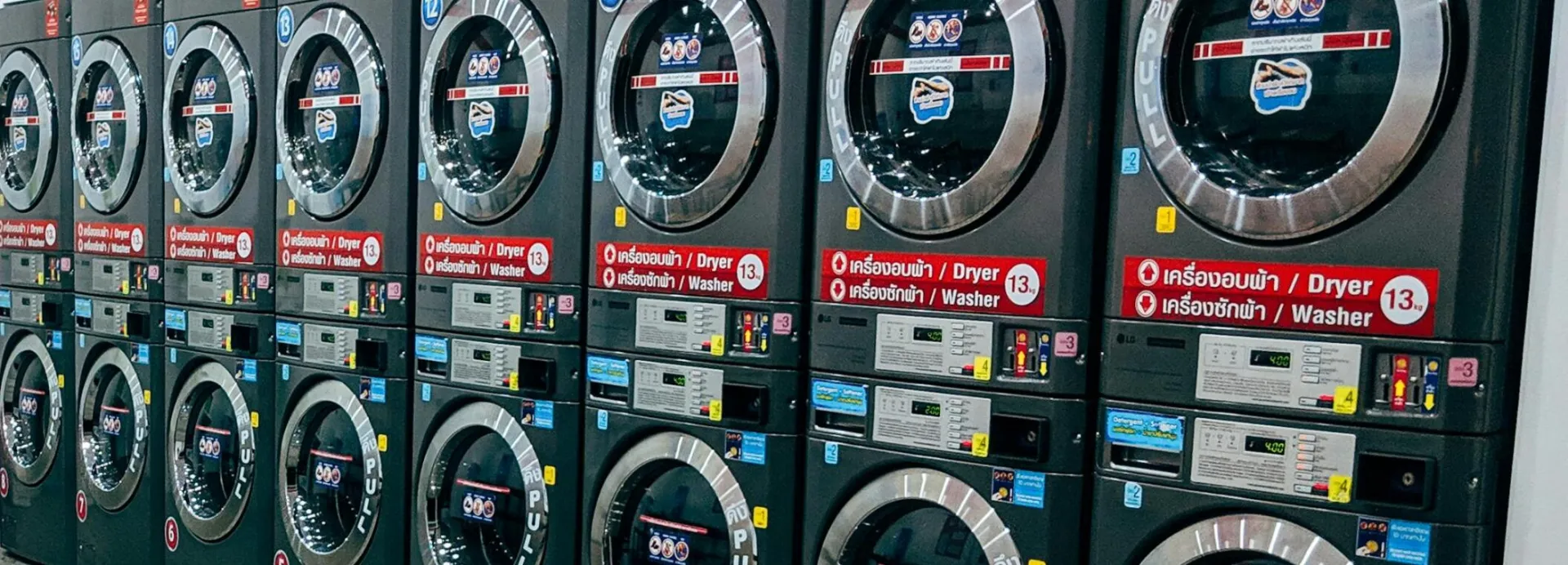 Spacious laundromat with multiple washing machines and seating area for convenience.