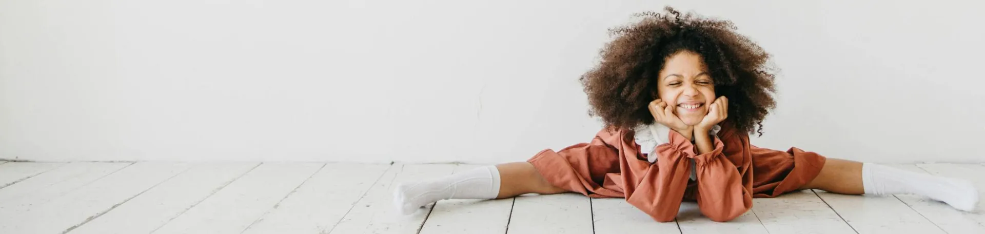 Smiling child engaging in creative art with playful expression indoors.