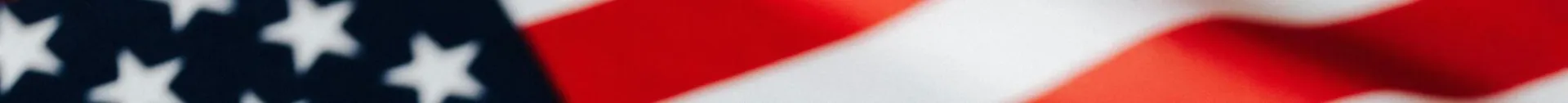 From above of closeup flattering national flag of USA with white and red stripes and stars on blue background