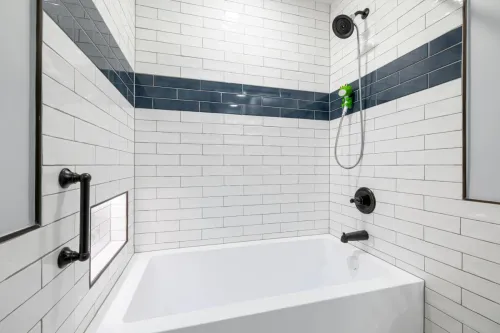 Sleek, minimalist bathroom with white and blue tiles and contemporary fixtures.
