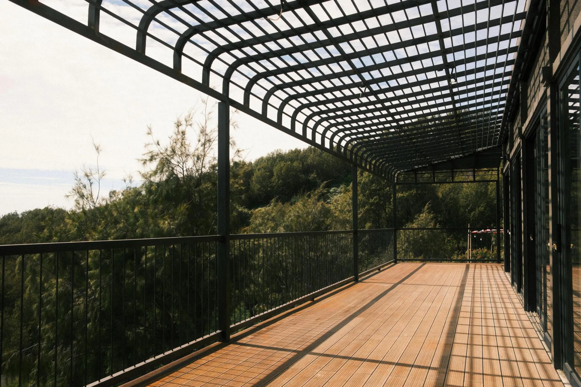 Elegant outdoor terrace in Jawa Timur, Indonesia, offering scenic forest views.