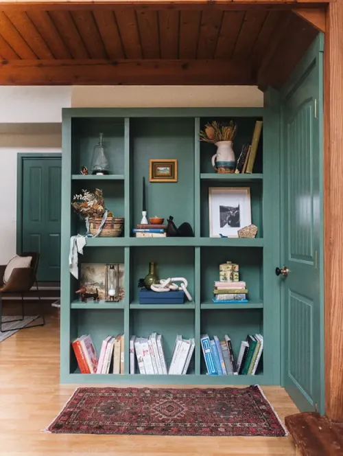 Elegant modern walk-in closet with wooden sliding door and empty shelves in a sleek minimalist style.