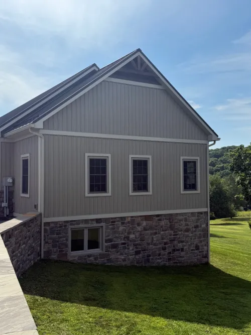Inviting suburban home with a distinctive blue front door and well-kept shrubs.