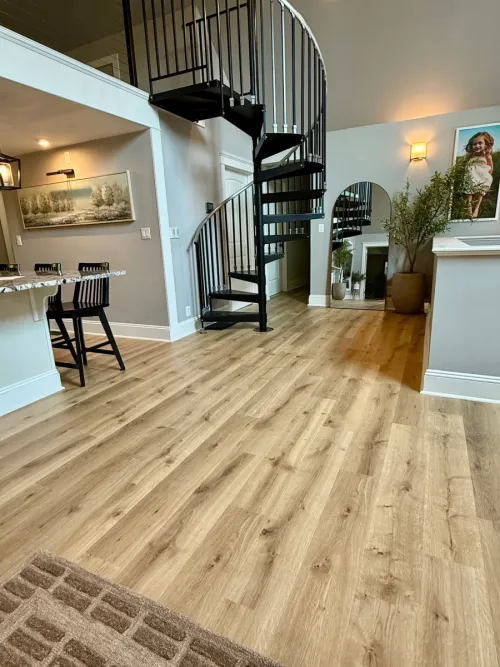 Empty basement room with neutral carpet and recessed lighting.