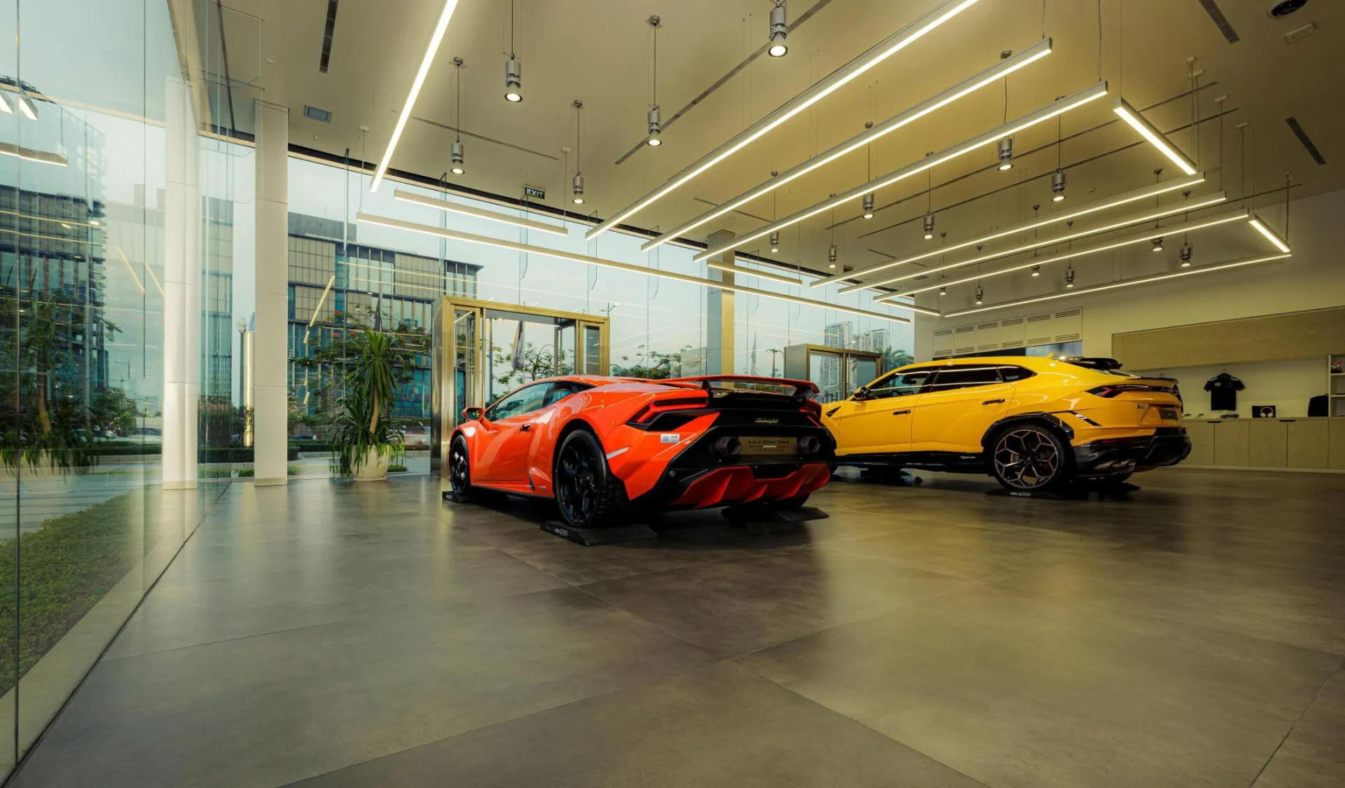 Showroom featuring luxury sports cars, Lamborghini models, with sleek design and modern architecture.