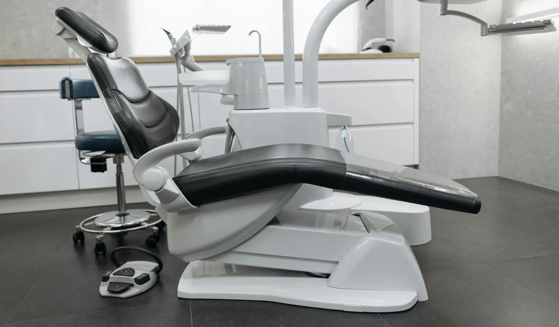 A contemporary dental office with a sleek dental chair and equipment, perfect for healthcare themed needs.
