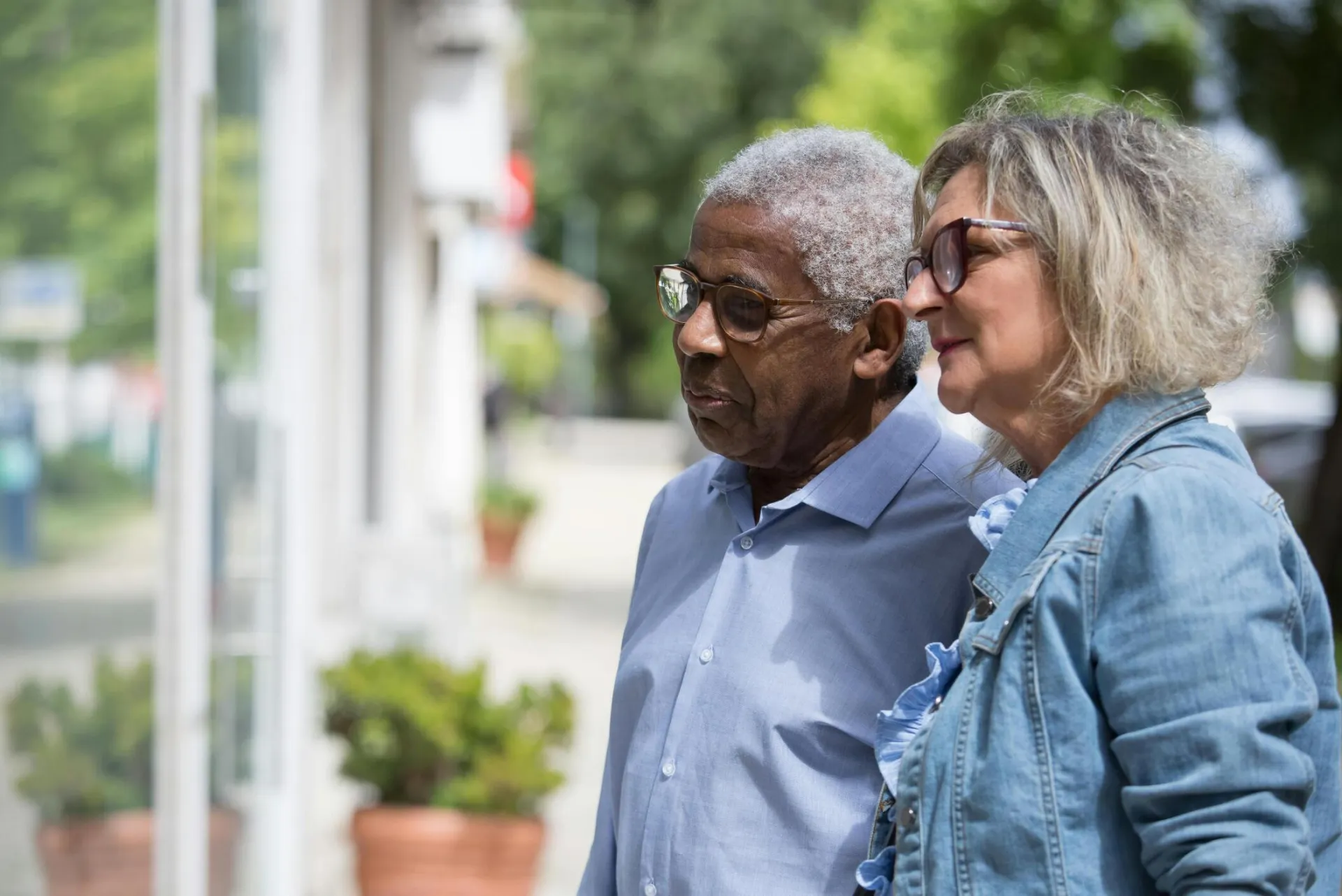 A close-up of a joyful elderly couple walking outdoors, enjoying a sunny day.