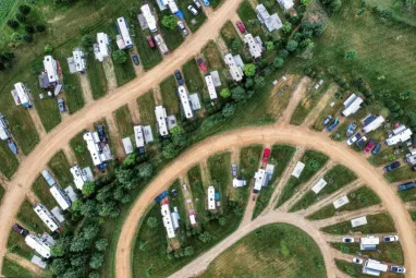 Aerial shot of trailer homes arranged in a curved layout in Nelson, Wisconsin. Captures rural landscape.