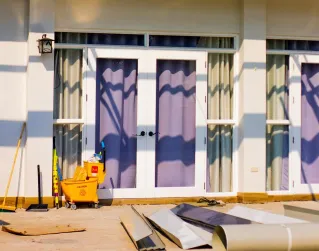 Construction materials and scaffolding seen during a house renovation project.