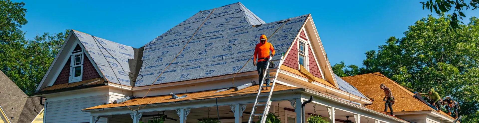 Roofers replace the roof of a historic home in Weatherford, Texas.