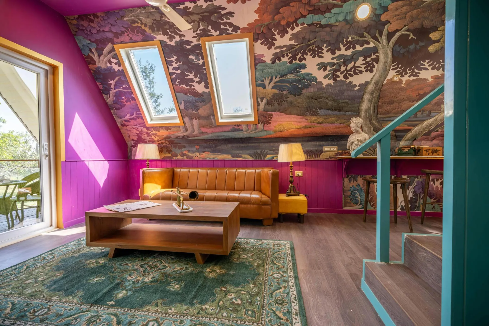 Vibrant living room featuring colorful wallpaper, skylights, and modern decor.