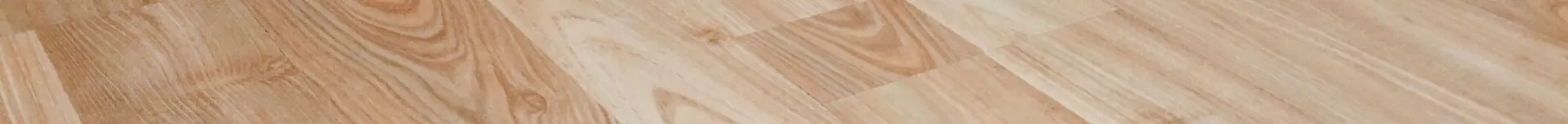 Smooth light brown wooden flooring with natural texture and patterns.