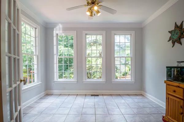 Spacious and bright interior room with large glass windows and tiled floor, perfect for home design inspiration.