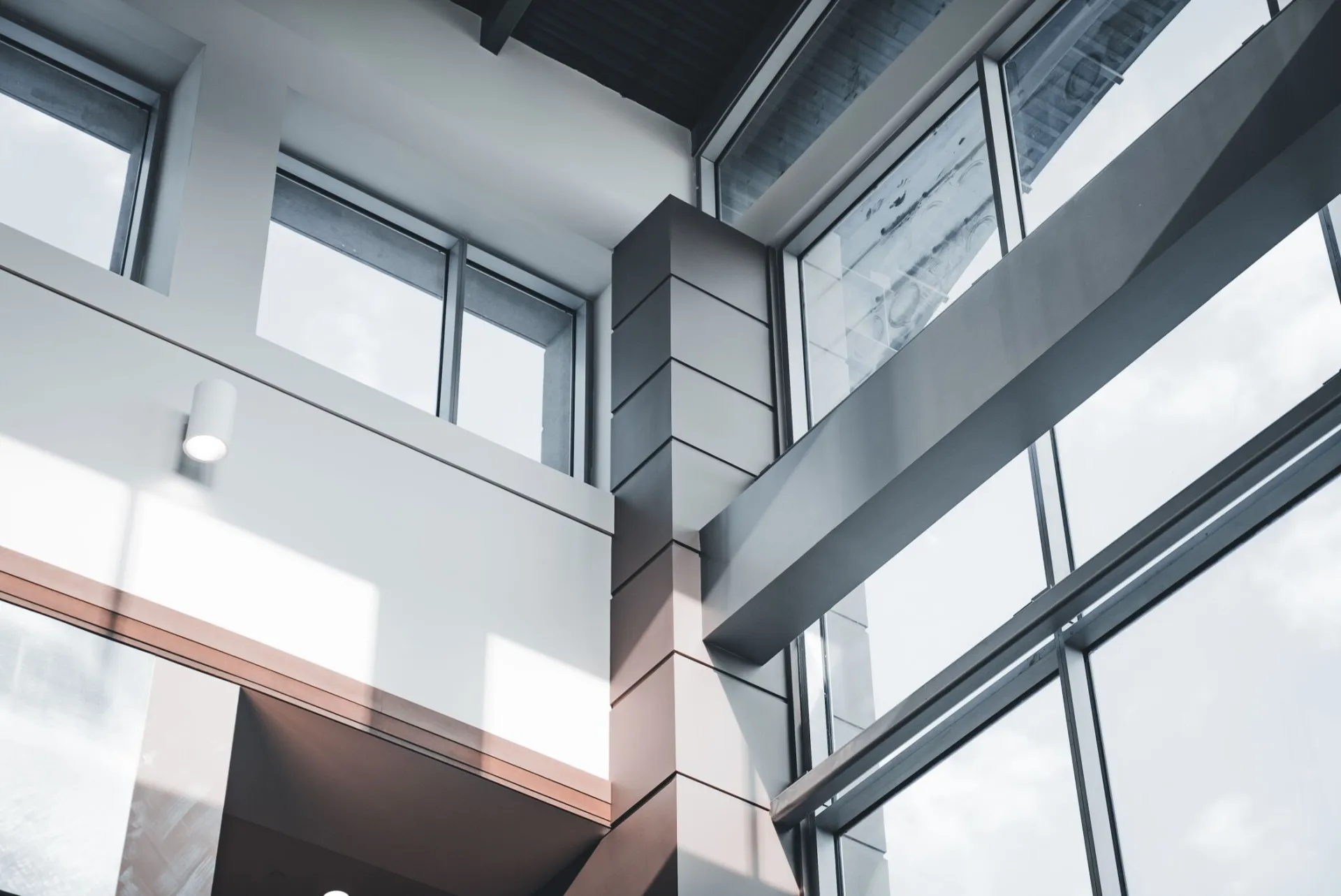 A modern architectural interior focusing on minimalist design and large windows.