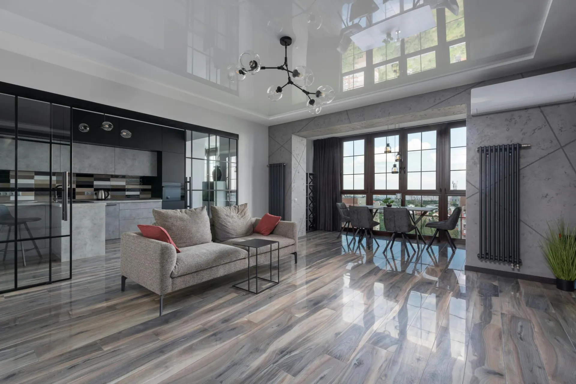 Spacious living room with modern furnishings and large windows offering bright natural light.