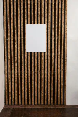 White mock up paper with copy space hanging on wall decorated with wooden planks in light room in modern studio