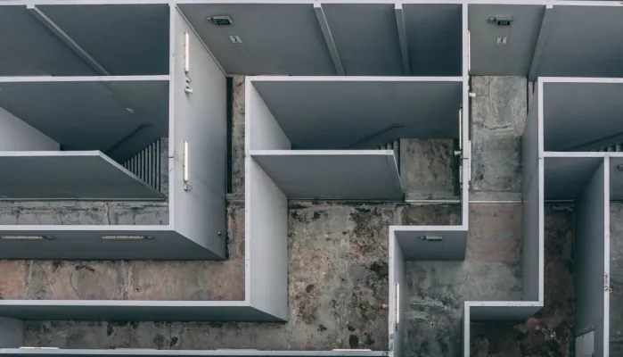 Aerial view of a complex indoor labyrinth made of concrete walls.