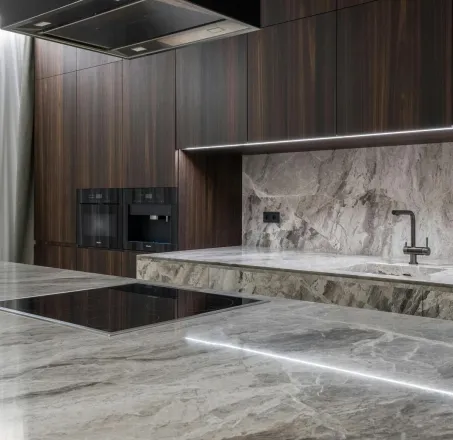 Interior design of spacious stylish modern kitchen with induction stove and air extraction system with wooden cupboards