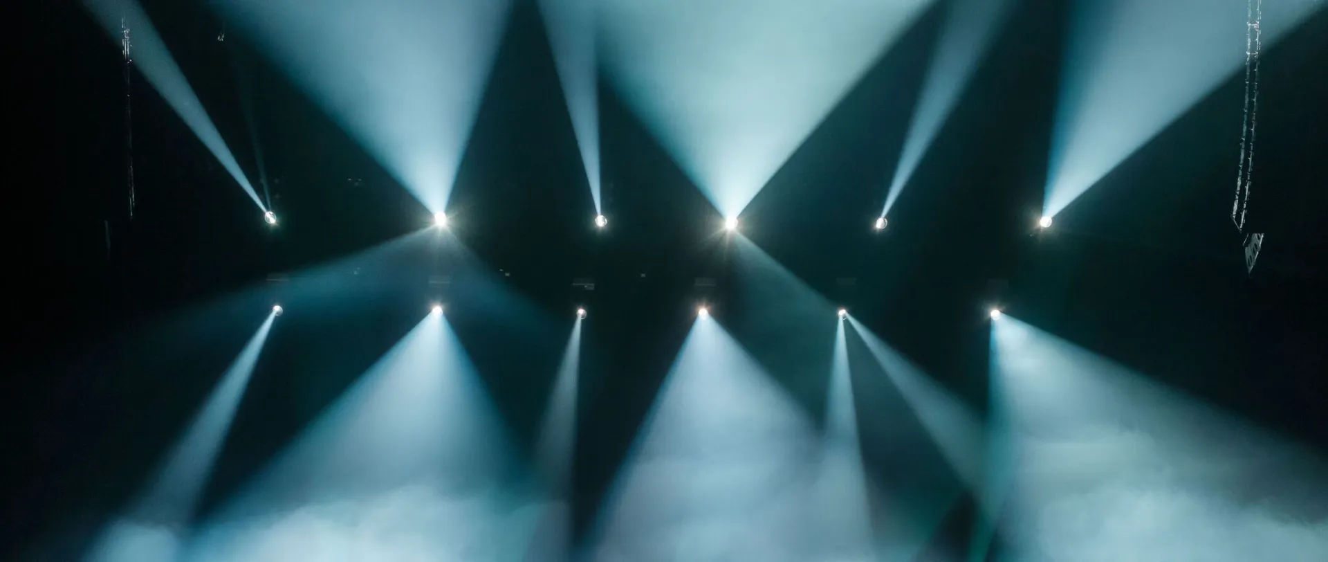 A dynamic concert scene with a large crowd enjoying vibrant stage lighting and a lively atmosphere.