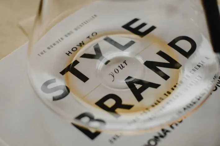A coffee pot rests atop a book titled 'How to Style Your Brand', capturing the essence of creative branding.